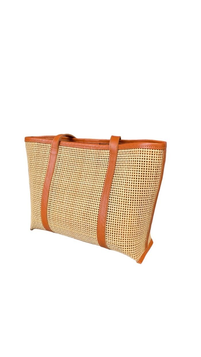 This stylish handbag is handcrafted in Bali using natural rattan material, The intricate weave creates a unique, one-of-a-kind design that is perfect for adding a touch of rustic charm to any outfit.