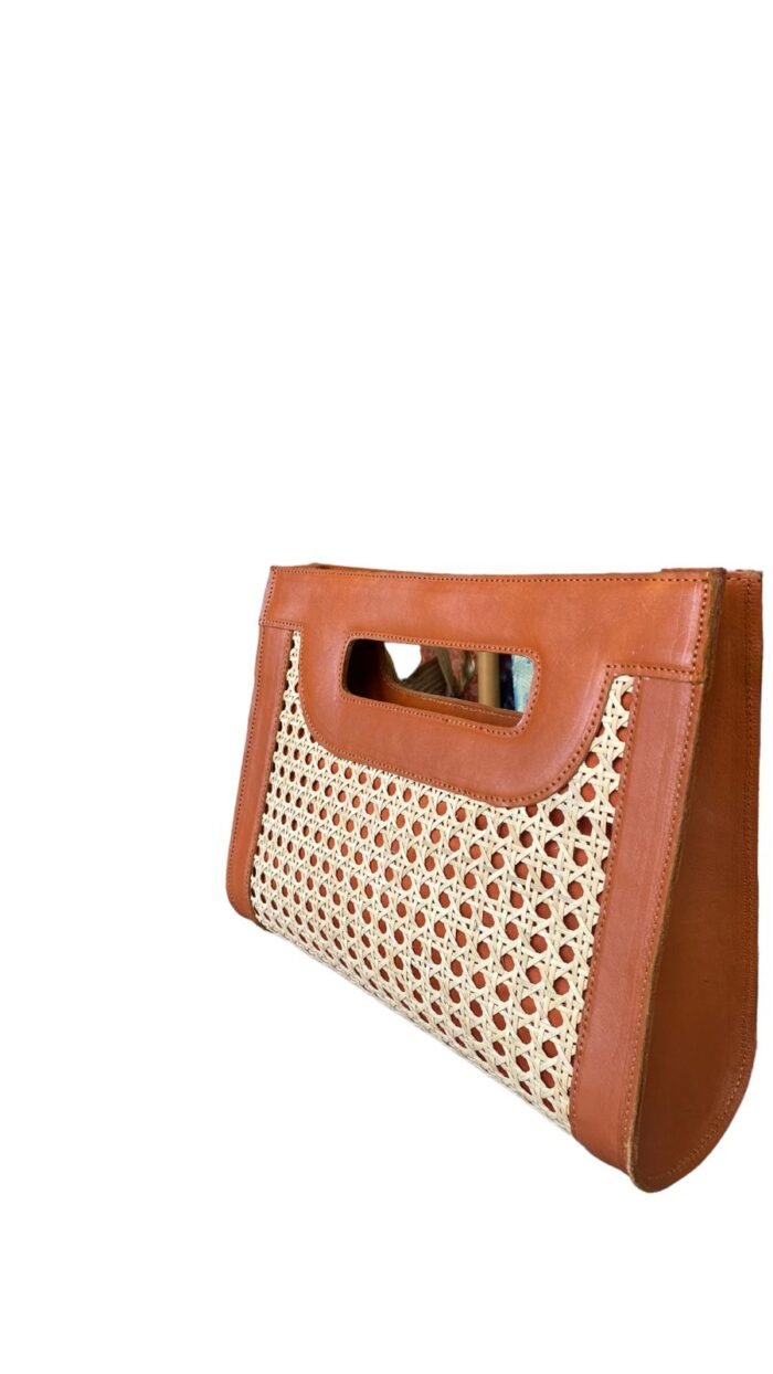 This stylish handbag is handcrafted in Bali using natural rattan material, The intricate weave creates a unique, one-of-a-kind design that is perfect for adding a touch of rustic charm to any outfit.