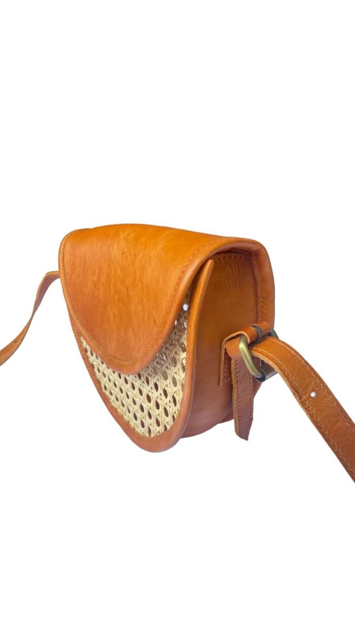 This stylish leather handbag is handcrafted in Bali using natural rattan material, The intricate weave creates a unique, one-of-a-kind design that is perfect for adding a touch of rustic charm to any outfit.