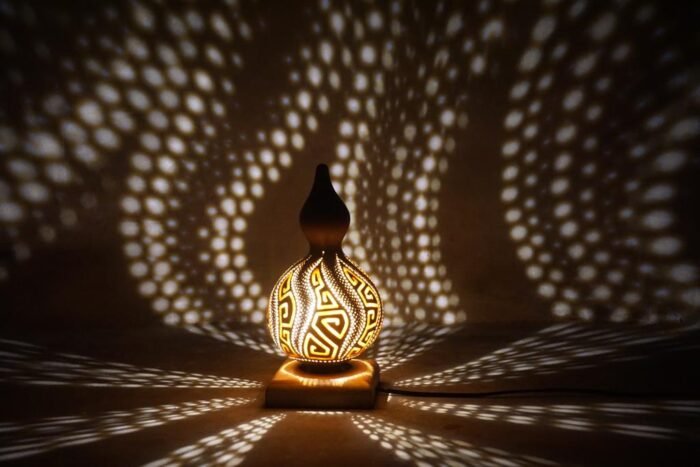 The Bali Flexible Gourd is a functional and visually stunning piece of home decor that adds elegance and sophistication to any room. With an intricate shadow pattern inspired by traditional Balinese art, it can be customized to suit your needs thanks to its flexible design. -Led Lamp 4 Watt , E27 Input 220 Volt AC -Finishing Pernish Holder Iron Wood Size : Length : 20 cm , Width : 20 cm, Height : 30 cm | Shipping Weight : 0.5 Kg