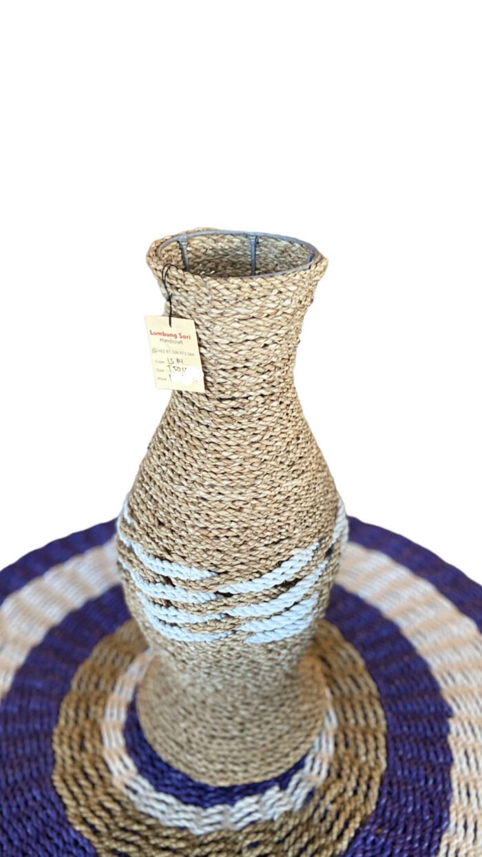 The Bali Natural Wicker Vase is a beautiful, eco-friendly home decor piece handmade in Bali. It has a unique texture and neutral color, making it versatile for any living space. Its size is perfect for holding fresh flowers or as a statement piece. Size : Height 50 cm | Shipping Weight : 5 kg