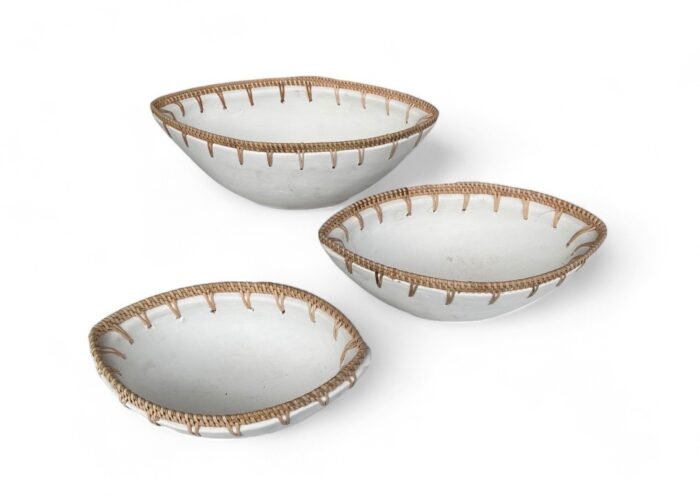 a group of bowls with a white surface