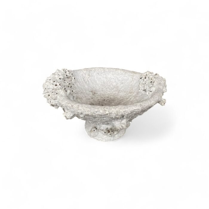 Handcrafted in Bali, this cement pottery features intricate coral and shell-inspired designs. Made with exceptional detail by skilled artisans, it adds a touch of coastal elegance to any space. Perfect for decor or functional use, each piece is a unique work of art.