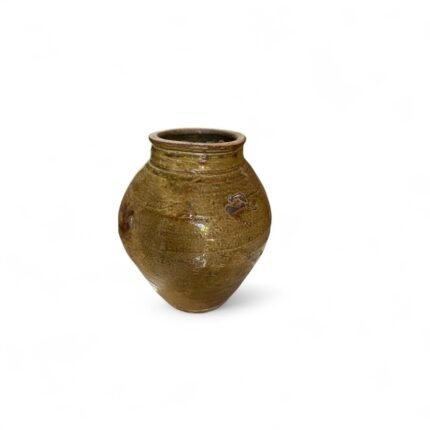 Step into the past with this Antique Clay Pot from Kalimantan, a timeless piece that tells a story of tradition, utility, and craftsmanship. This pot is not just a decorative object – it's a tangible connection to the heritage of Kalimantan, where such vessels were integral in daily village life long before modern containers came into use. Made from natural ceramic clay, this antique pot was traditionally used for storing rice, water, and even fermenting fish – essential activities in the local culture of Kalimantan. Over decades of use and time, the pot has developed a naturally aged surface, with fine hairline cracks and deep earthy tones that only time and history can create. Each pot carries its own unique patina, shaped by weather, hand use, and natural material interaction. While no longer used for food or liquid storage, the pot now serves a different purpose: a decorative statement piece that radiates authenticity and age. This piece is favored by collectors, interior designers, and decor enthusiasts who are looking for items that bring both story and soul into a space. Place it in an entryway, on a patio, in a living room, or pair it with other antique finds for a stunning gallery effect. Though originally designed for utility, these pots are now celebrated for their aesthetic imperfections – the subtle uneven texture, the hand-formed lip, and even the soft chips or weathered rim. No two are ever the same, making each one a one-of-a-kind historical treasure. Product Highlights: Material: Ceramic clay Origin: Kalimantan, Indonesia Original Use: For rice storage, water containers, and fish fermentation Current Use: Home decor, gallery display, collector's item Condition: Antique, with authentic aging, fine cracks, and color variations Note: For decorative use only Size: Approximately 35 x 40 x 35 cm Cultural Significance: Before the widespread availability of plastic or metal containers, this type of clay pot played a vital role in food preservation and daily life. Crafted by hand and shaped using traditional techniques, it reflects both the skills of past artisans and the natural resources of the region. In many communities, a pot like this would be passed down through generations, holding stories of family life, harvest seasons, and traditional recipes. Some were even used in ceremonial practices. Today, these pots serve as a reminder of the rich cultural tapestry of Indonesia and the sustainability of handcrafted, locally sourced items. Ideal For: Antique Collectors Bohemian, rustic, or ethnic-themed interiors Interior stylists and decorators Photography or movie props Art installations and museum collections Why This Pot? Sustainably sourced: No replicas. This is an original vintage piece. Emotionally resonant: Holds a deep connection to Indonesian heritage. Timeless design: Will never go out of style in vintage decor. How to Purchase: Since each piece is one-of-a-kind, please contact us with a screenshot or a description of the pot you wish to order. Availability changes quickly due to its rarity. If the selected pot is no longer available, we will recommend another similar piece from our collection. Feel free to message us before checkout to confirm stock.