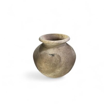 Step into the past with this Antique Clay Pot from Kalimantan, a timeless piece that tells a story of tradition, utility, and craftsmanship. This pot is not just a decorative object – it's a tangible connection to the heritage of Kalimantan, where such vessels were integral in daily village life long before modern containers came into use. Made from natural ceramic clay, this antique pot was traditionally used for storing rice, water, and even fermenting fish – essential activities in the local culture of Kalimantan. Over decades of use and time, the pot has developed a naturally aged surface, with fine hairline cracks and deep earthy tones that only time and history can create. Each pot carries its own unique patina, shaped by weather, hand use, and natural material interaction. While no longer used for food or liquid storage, the pot now serves a different purpose: a decorative statement piece that radiates authenticity and age. This piece is favored by collectors, interior designers, and decor enthusiasts who are looking for items that bring both story and soul into a space. Place it in an entryway, on a patio, in a living room, or pair it with other antique finds for a stunning gallery effect. Though originally designed for utility, these pots are now celebrated for their aesthetic imperfections – the subtle uneven texture, the hand-formed lip, and even the soft chips or weathered rim. No two are ever the same, making each one a one-of-a-kind historical treasure. Product Highlights: Material: Ceramic clay Origin: Kalimantan, Indonesia Original Use: For rice storage, water containers, and fish fermentation Current Use: Home decor, gallery display, collector's item Condition: Antique, with authentic aging, fine cracks, and color variations Note: For decorative use only Size: Approximately 35 x 40 x 35 cm Cultural Significance: Before the widespread availability of plastic or metal containers, this type of clay pot played a vital role in food preservation and daily life. Crafted by hand and shaped using traditional techniques, it reflects both the skills of past artisans and the natural resources of the region. In many communities, a pot like this would be passed down through generations, holding stories of family life, harvest seasons, and traditional recipes. Some were even used in ceremonial practices. Today, these pots serve as a reminder of the rich cultural tapestry of Indonesia and the sustainability of handcrafted, locally sourced items. Ideal For: Antique Collectors Bohemian, rustic, or ethnic-themed interiors Interior stylists and decorators Photography or movie props Art installations and museum collections Why This Pot? Sustainably sourced: No replicas. This is an original vintage piece. Emotionally resonant: Holds a deep connection to Indonesian heritage. Timeless design: Will never go out of style in vintage decor. How to Purchase: Since each piece is one-of-a-kind, please contact us with a screenshot or a description of the pot you wish to order. Availability changes quickly due to its rarity. If the selected pot is no longer available, we will recommend another similar piece from our collection. Feel free to message us before checkout to confirm stock.